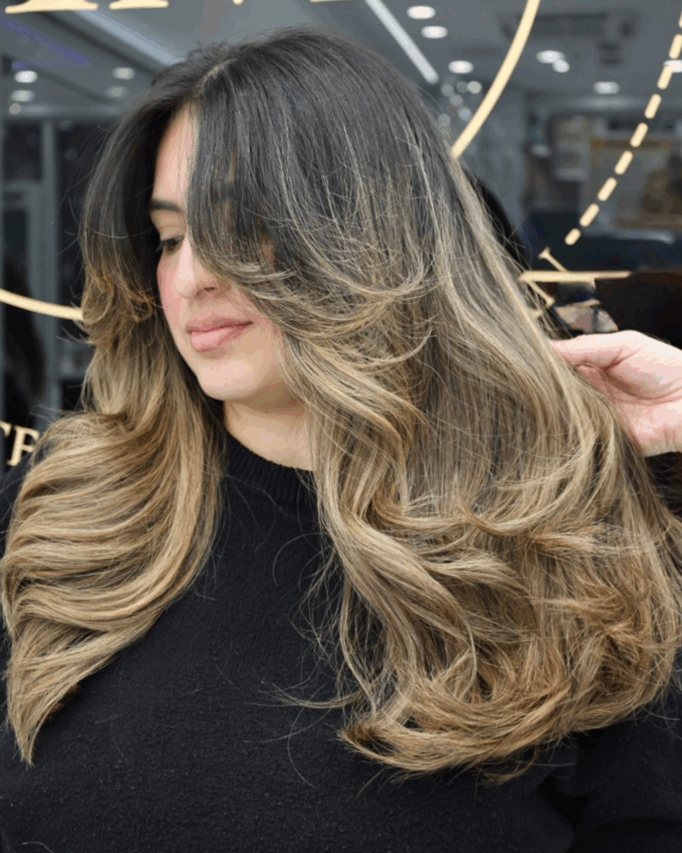 Dark-to-blonde balayage butterfly haircut by Tina