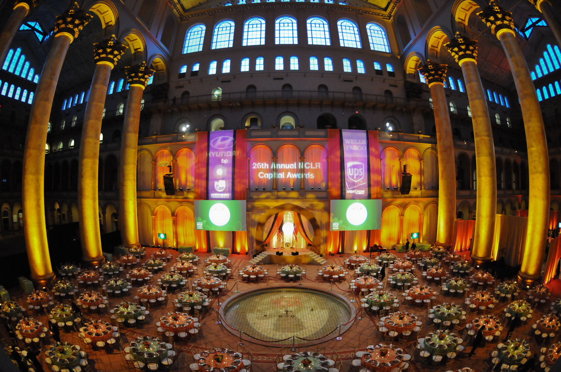 Grand ballroom aerial view with dramatic lighting and round tables set for dinner at the 26th Annual NCLR Capital Awards gala