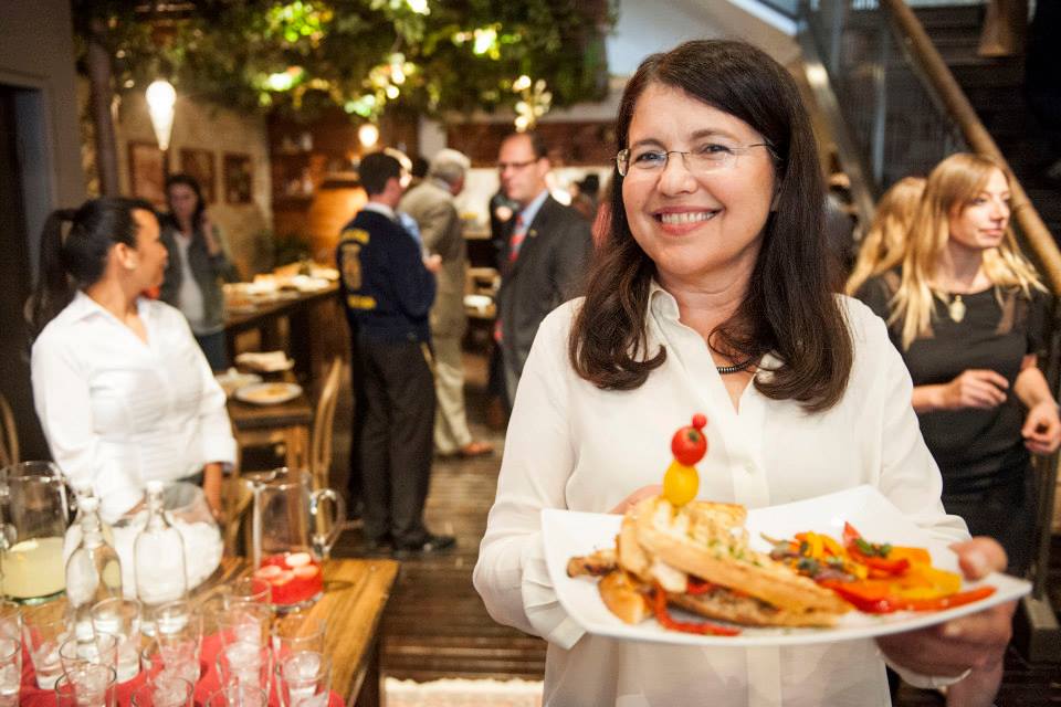 Woman holding a plate of food at the Sabra Hummus House pop-up