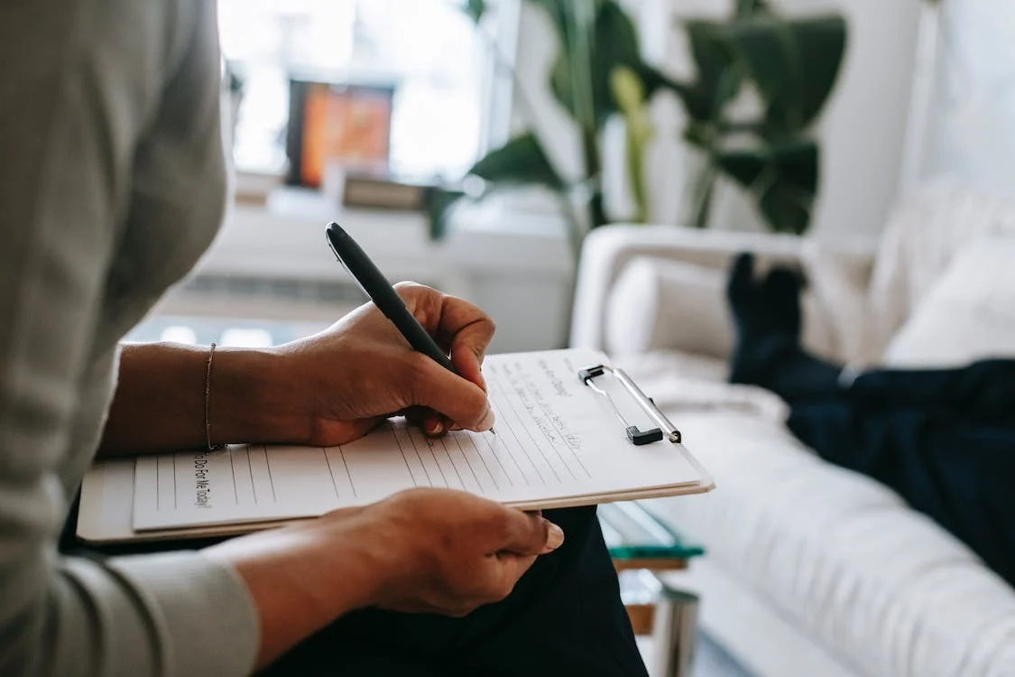 Hands taking notes during a consultation