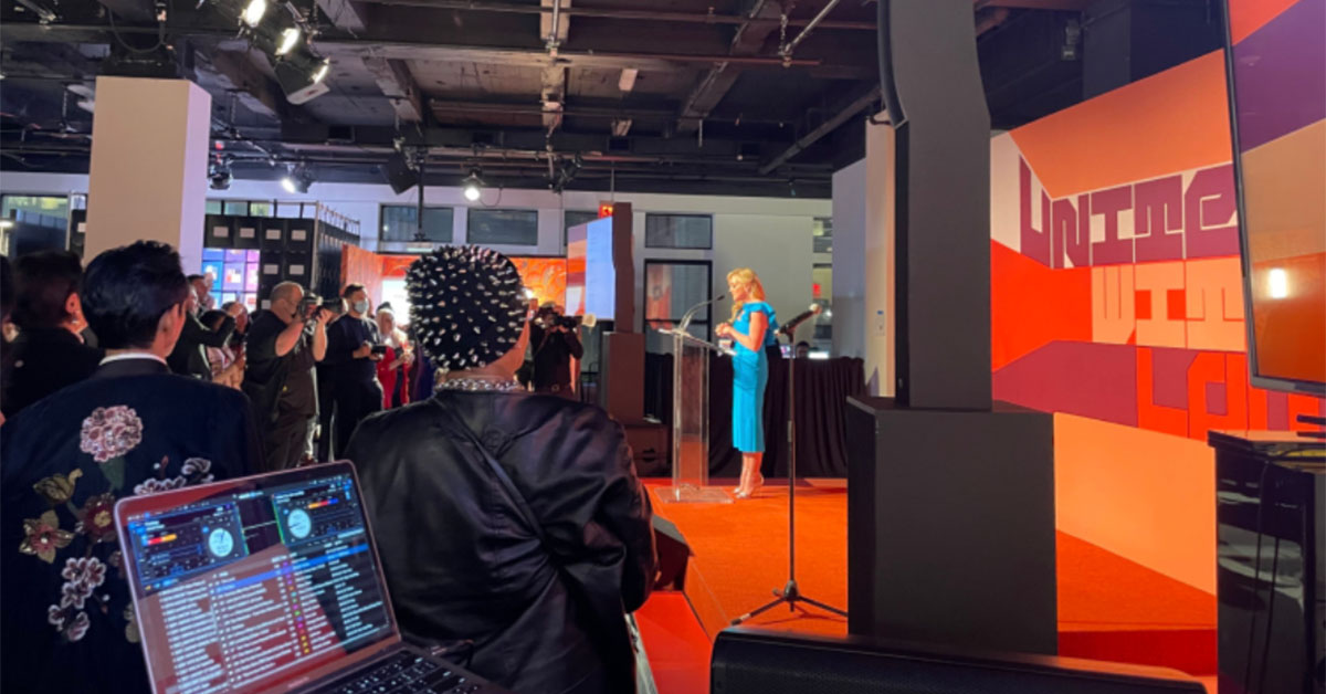 Live charity gala event with DJ, crowd and colorful backdrop