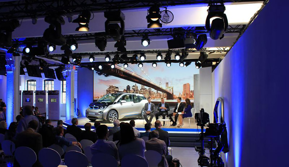 Automotive launch event with BMW i3 car on stage and blue stage lighting