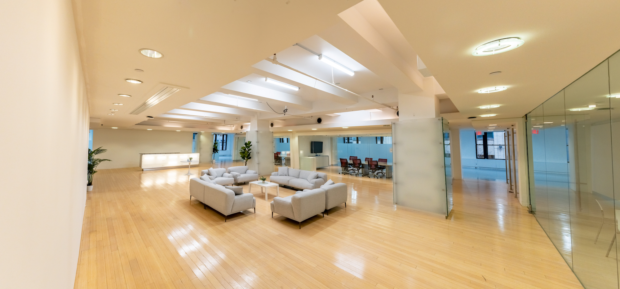 Annex417 bright open event floor with wood floors, lounge seating and glass-walled conference rooms