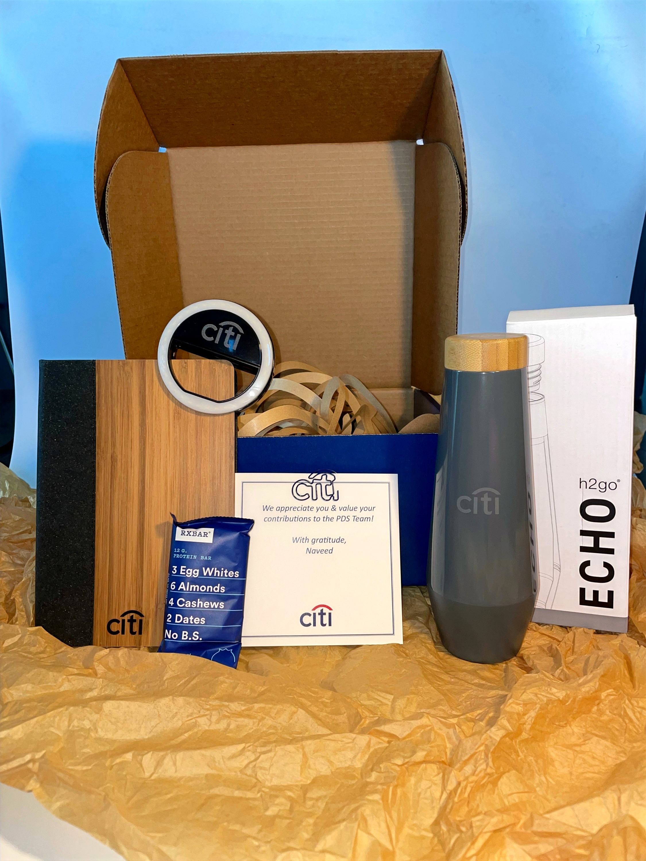 Citi-branded corporate gift box with water bottle, cutting board, ring light and bar