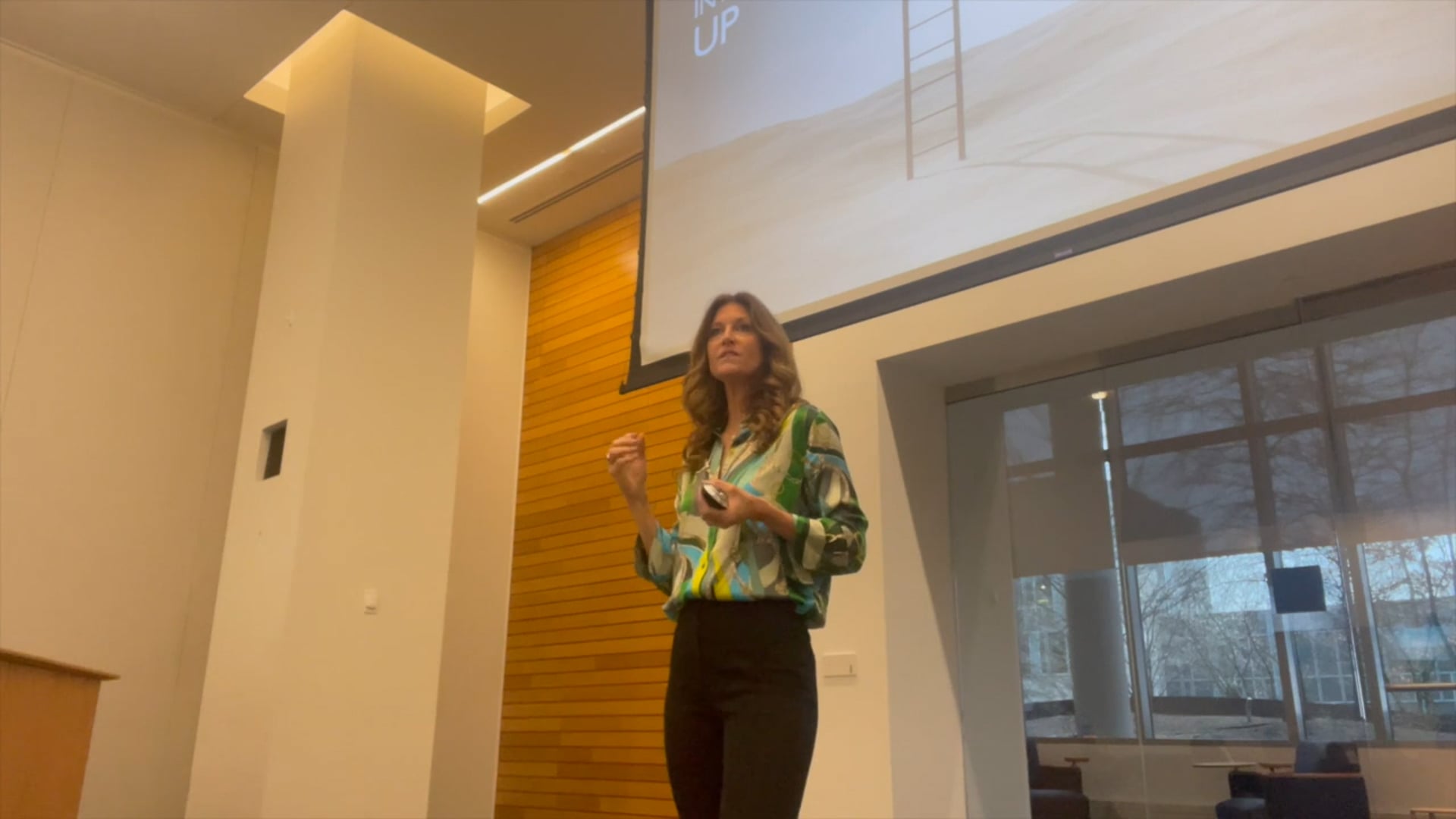 Andrea Marcellus presenting on stage at a corporate keynote