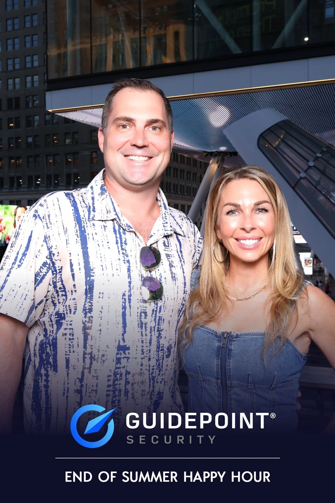 Two people at the GuidePoint Security End of Summer Happy Hour event with the NYC skyline behind them