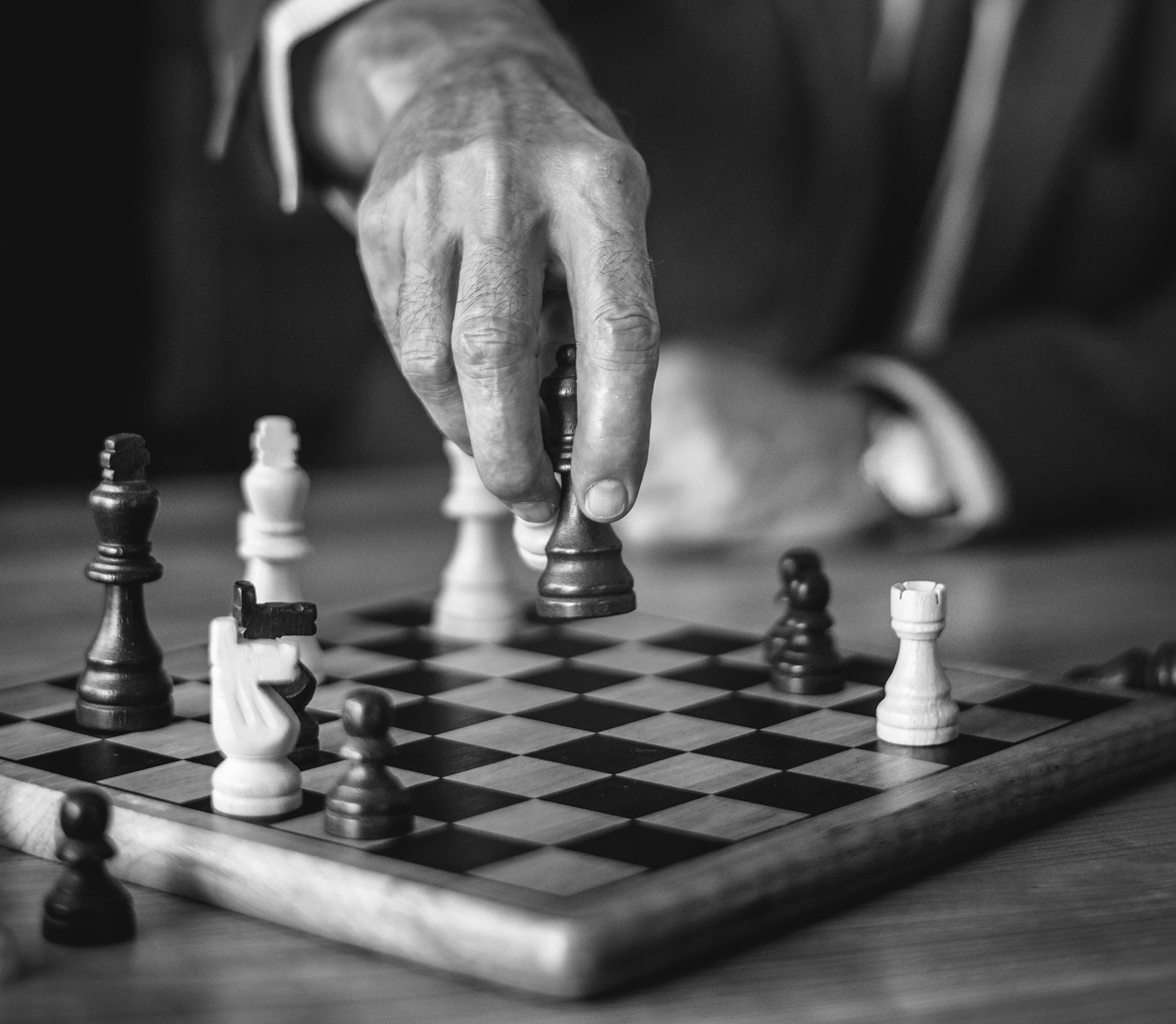 Close-up of a hand moving a chess piece