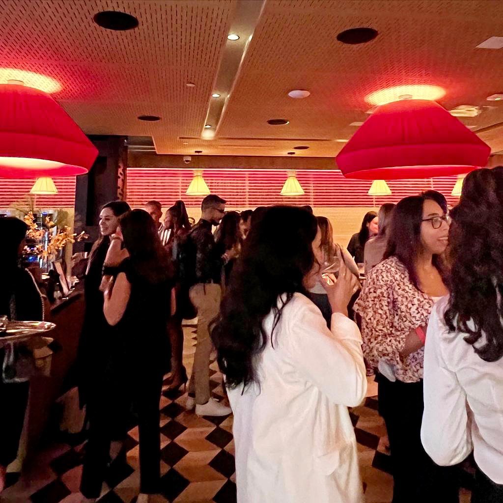 Cocktail networking under red pendant lamps