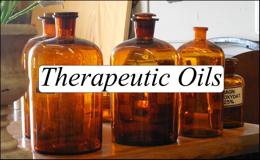 Row of amber apothecary bottles — Therapeutic Oils