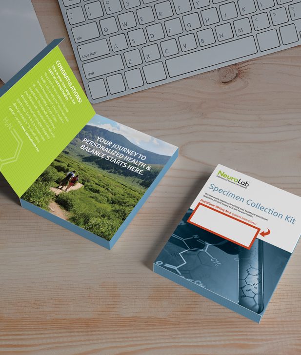 A NeuroLab specimen collection kit and booklet on a wooden desk