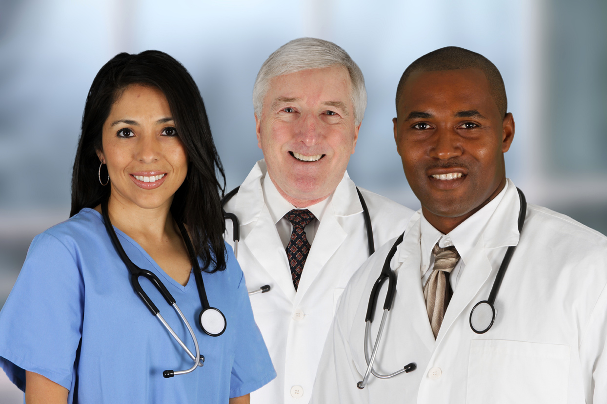 Three smiling healthcare professionals: a nurse in scrubs and two doctors in white coats with stethoscopes