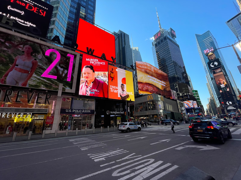 Times Square billboards including BritBox 'Murder in Provence' digital ad, daytime
