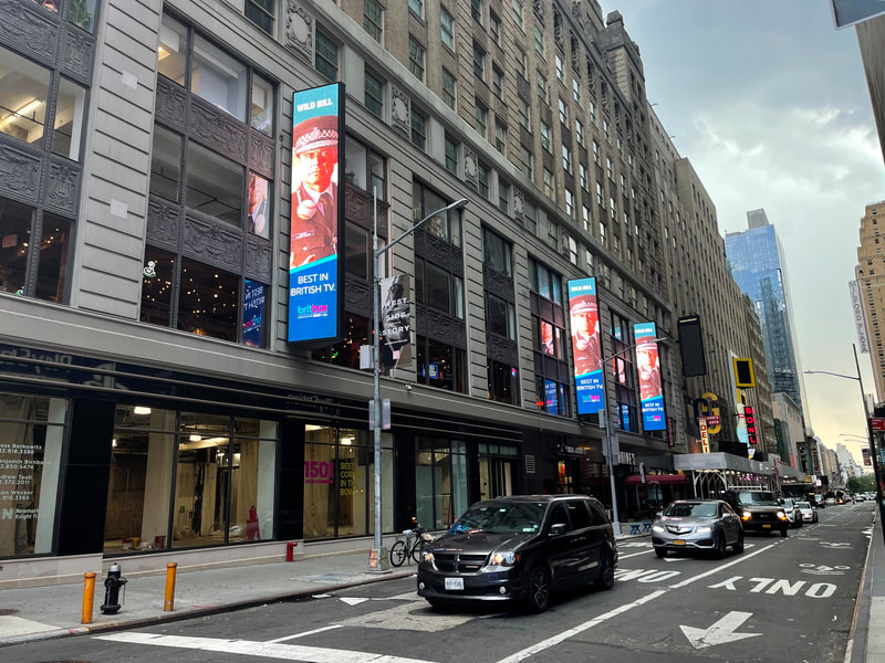 BritBox 'Wild Bill' vertical digital screens on building facade, Broadway theater district NYC