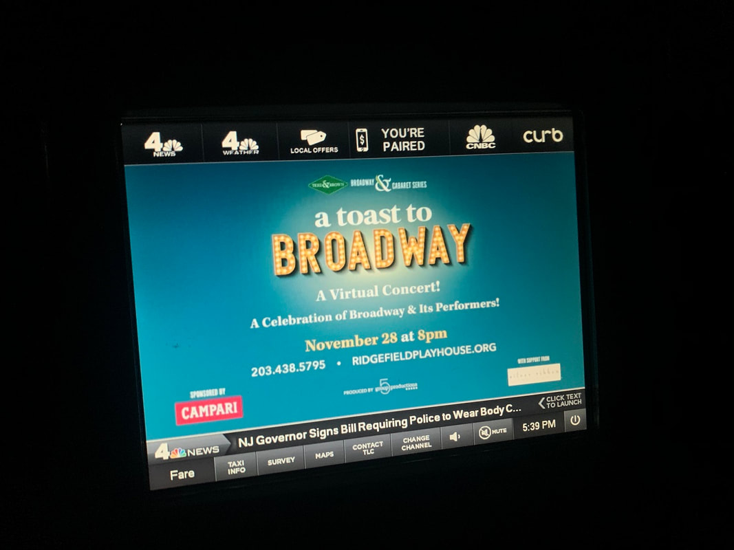NYC taxi backseat screen showing 'A Toast to Broadway' virtual concert ad