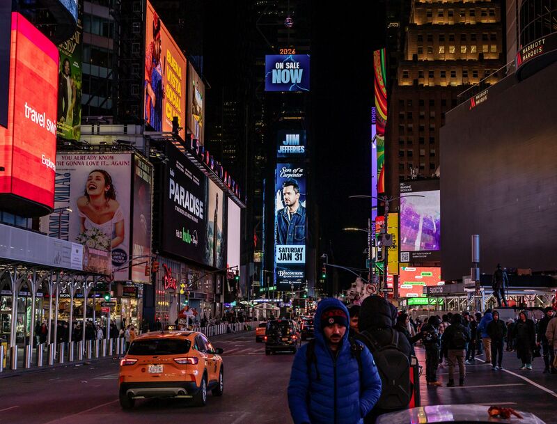 Jim Jefferies 'Son of a Carpenter' Times Square digital billboard at night, wide street scene