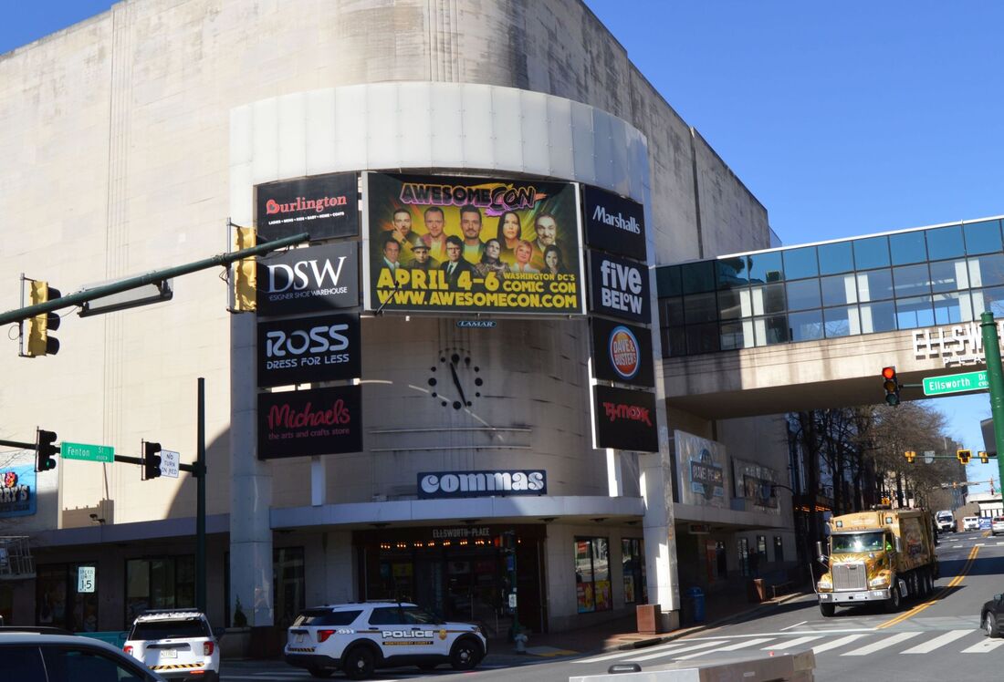 Awesome Con Washington DC comic convention billboard on a mall building exterior