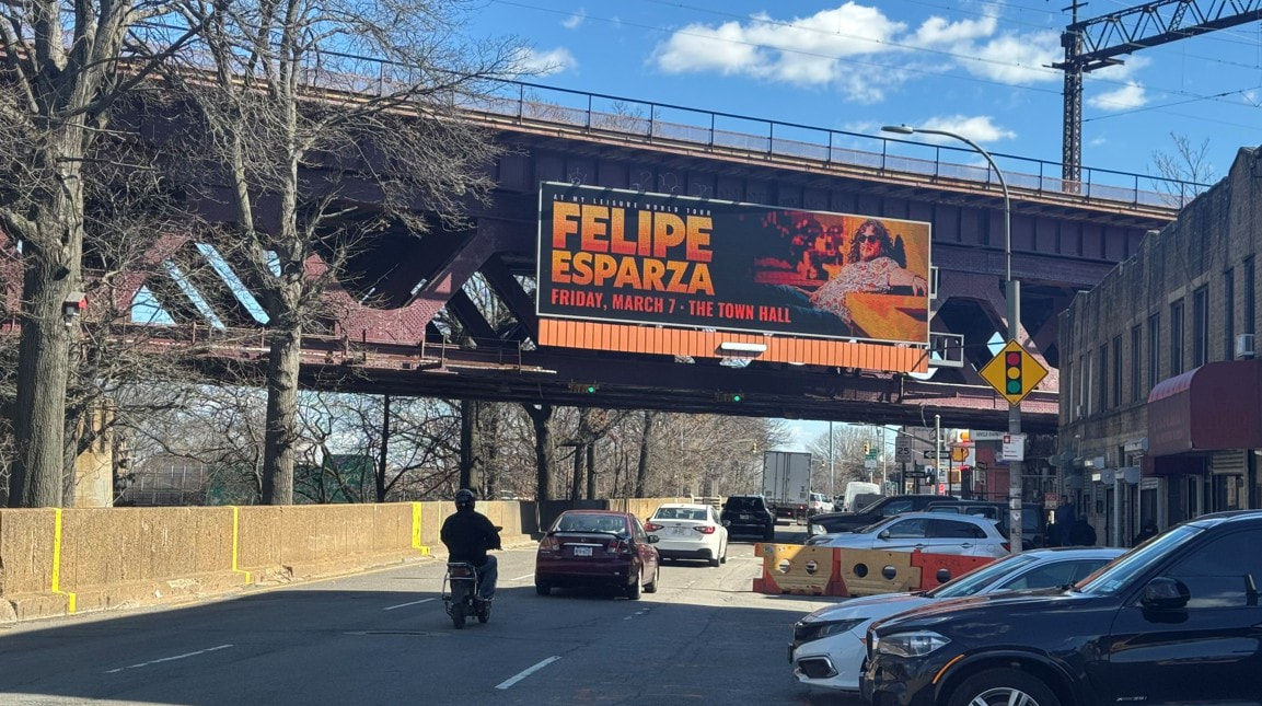 Felipe Esparza 'At My Leisure World Tour' billboard on an elevated railway structure in NYC