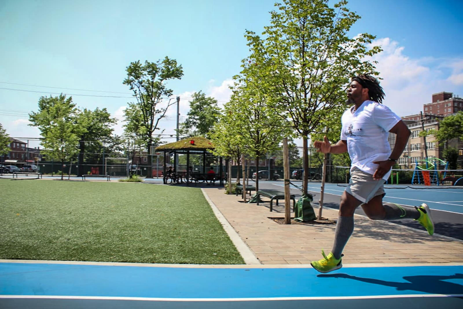 Man in a BDF shirt running on a track