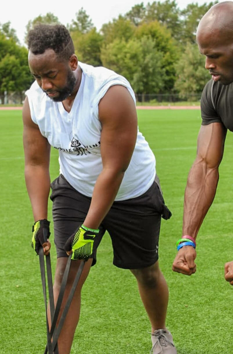 Coach Lord coaching a client with resistance bands