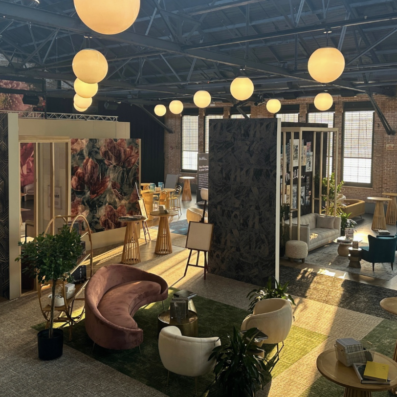 Branded booth interior with globe pendant lights and velvet seating