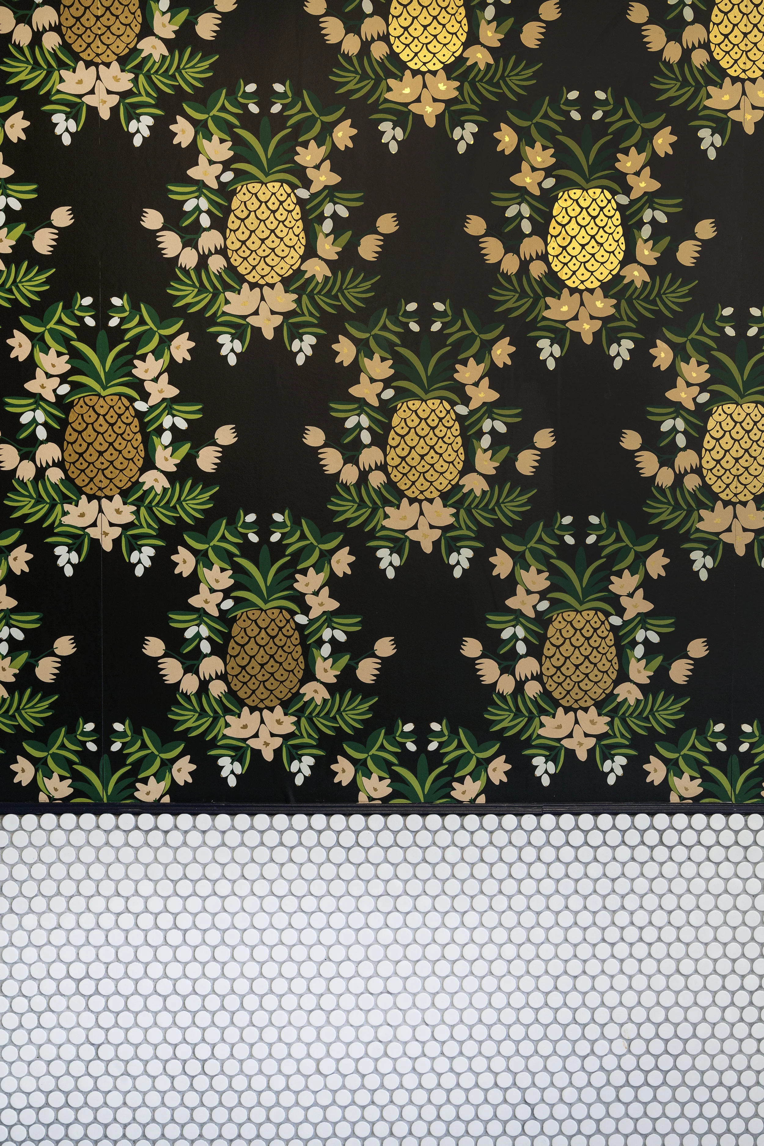 Full pineapple-pattern painted wall mural with white penny tile wainscoting