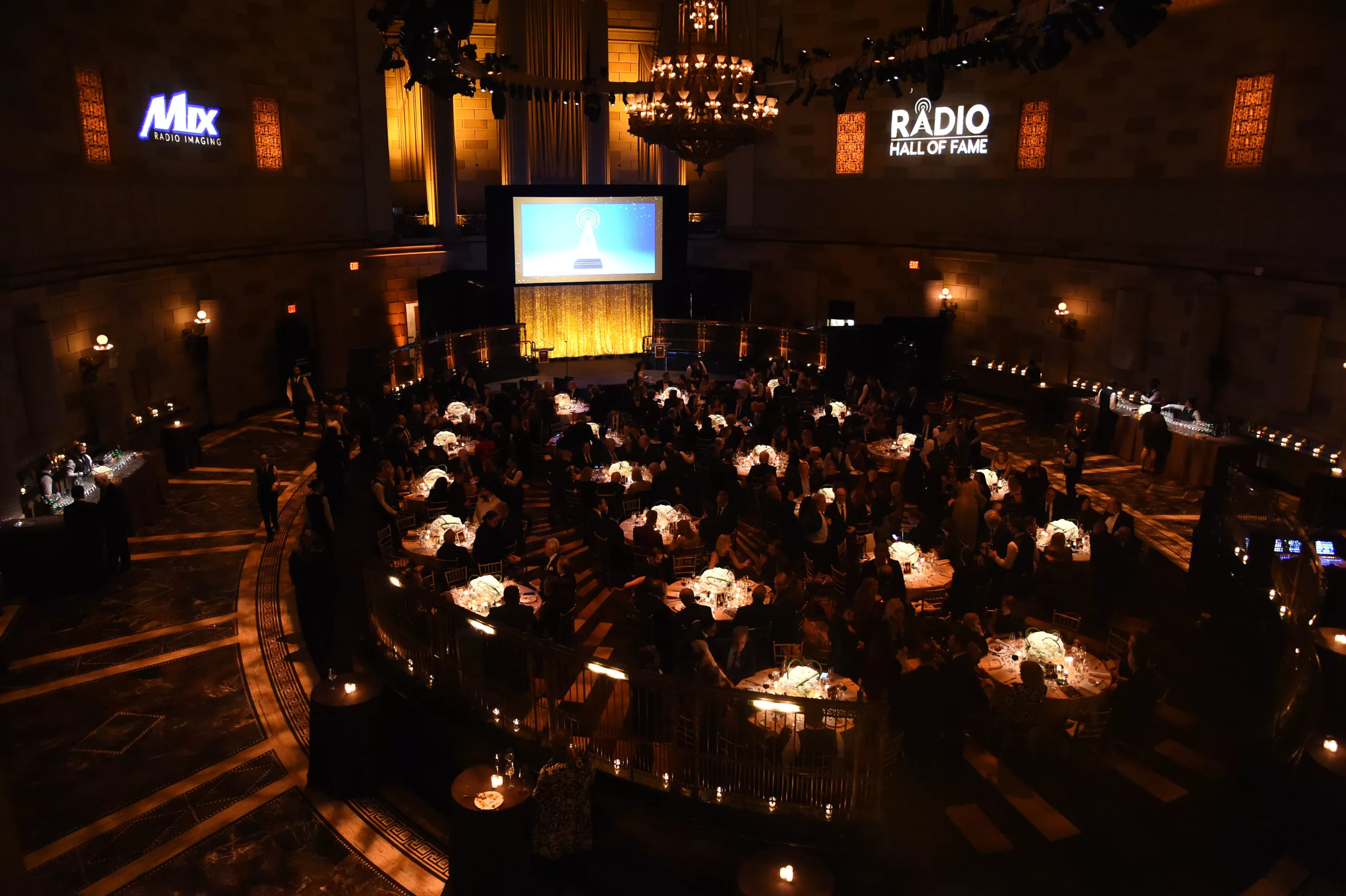 Overhead view of a formal Radio Hall of Fame gala in a grand chandeliered ballroom produced by Cassis Productions