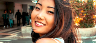 Smiling woman looking over her shoulder outdoors