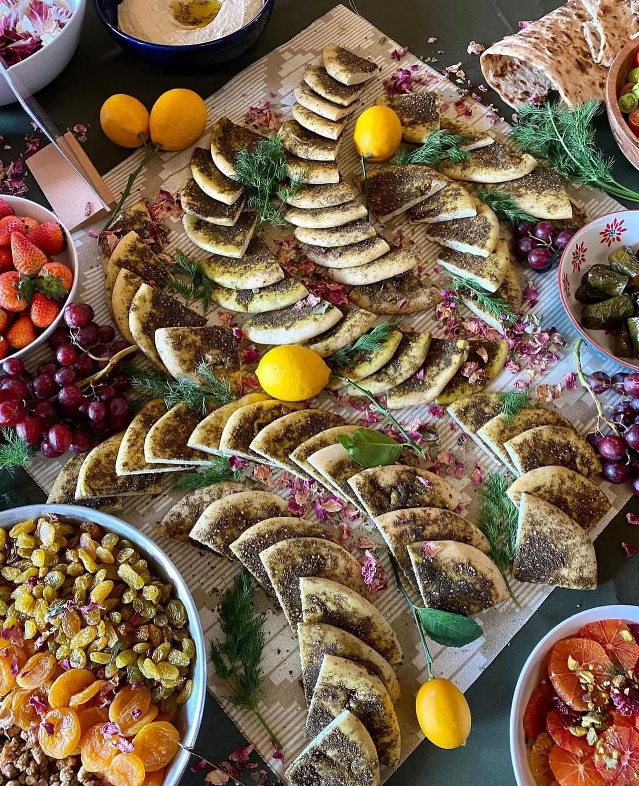 Middle Eastern flatbread za'atar display with dried fruits and lemons