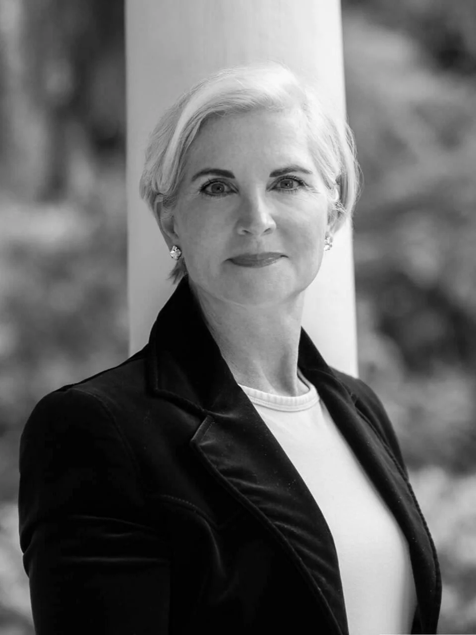 Christina Langdon in a black blazer, formal black and white portrait