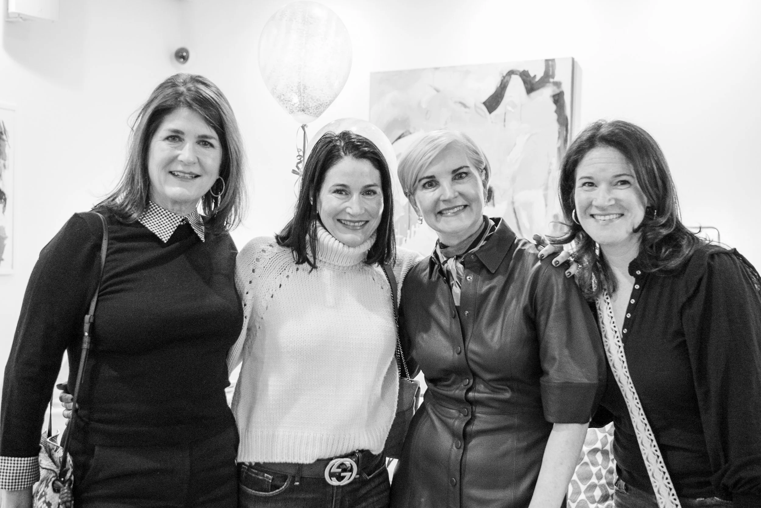 Four women posing together at Christina Langdon's book launch, black and white