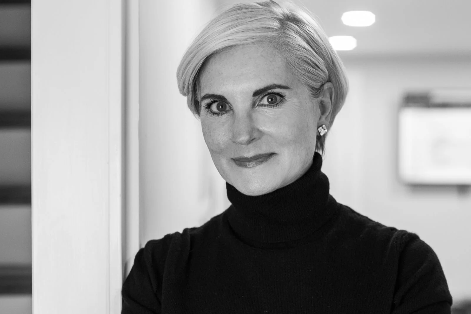 Christina Langdon, close-up black and white portrait in a black turtleneck