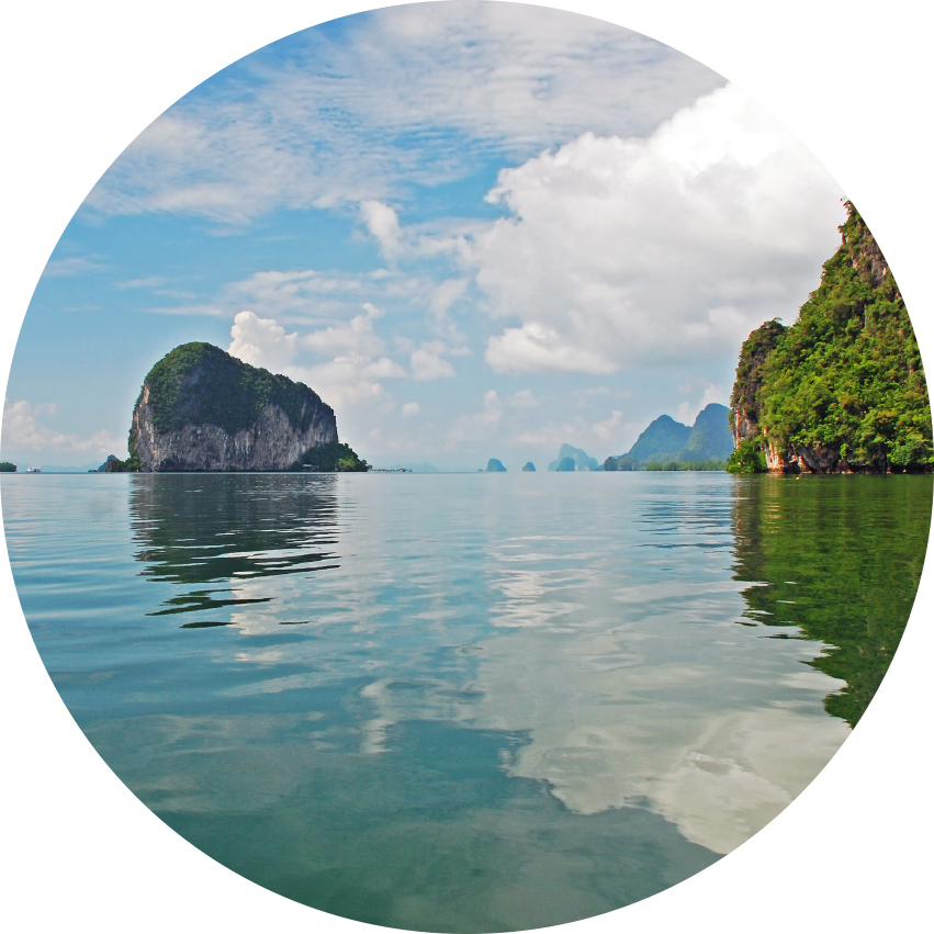 Limestone karst islands rising from calm turquoise water in Thailand