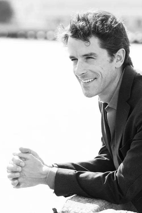 Black-and-white portrait of Chad Woodford smiling