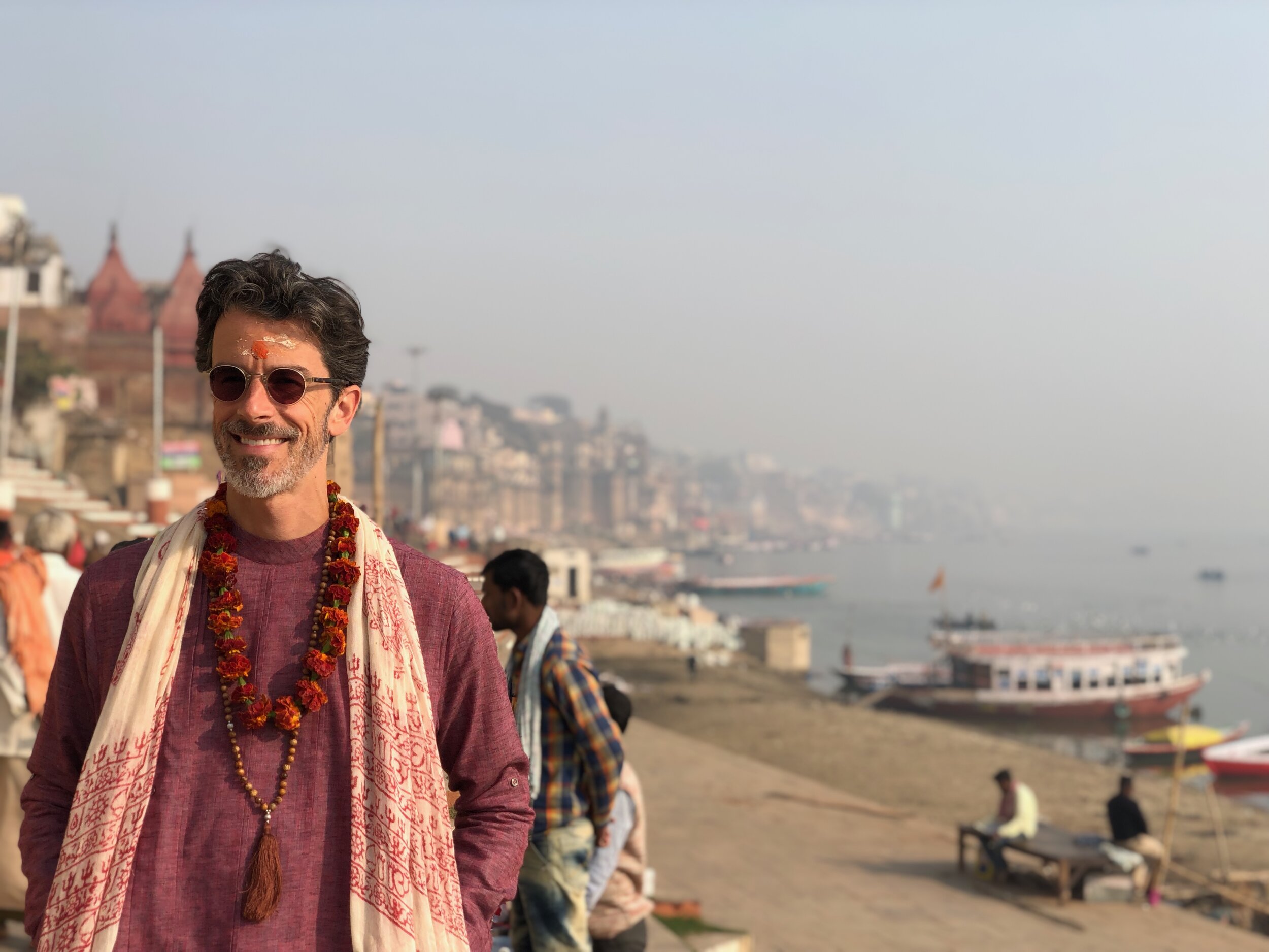 The sacred Varanasi ghats at golden hour — ancient steps descending to the timeless river