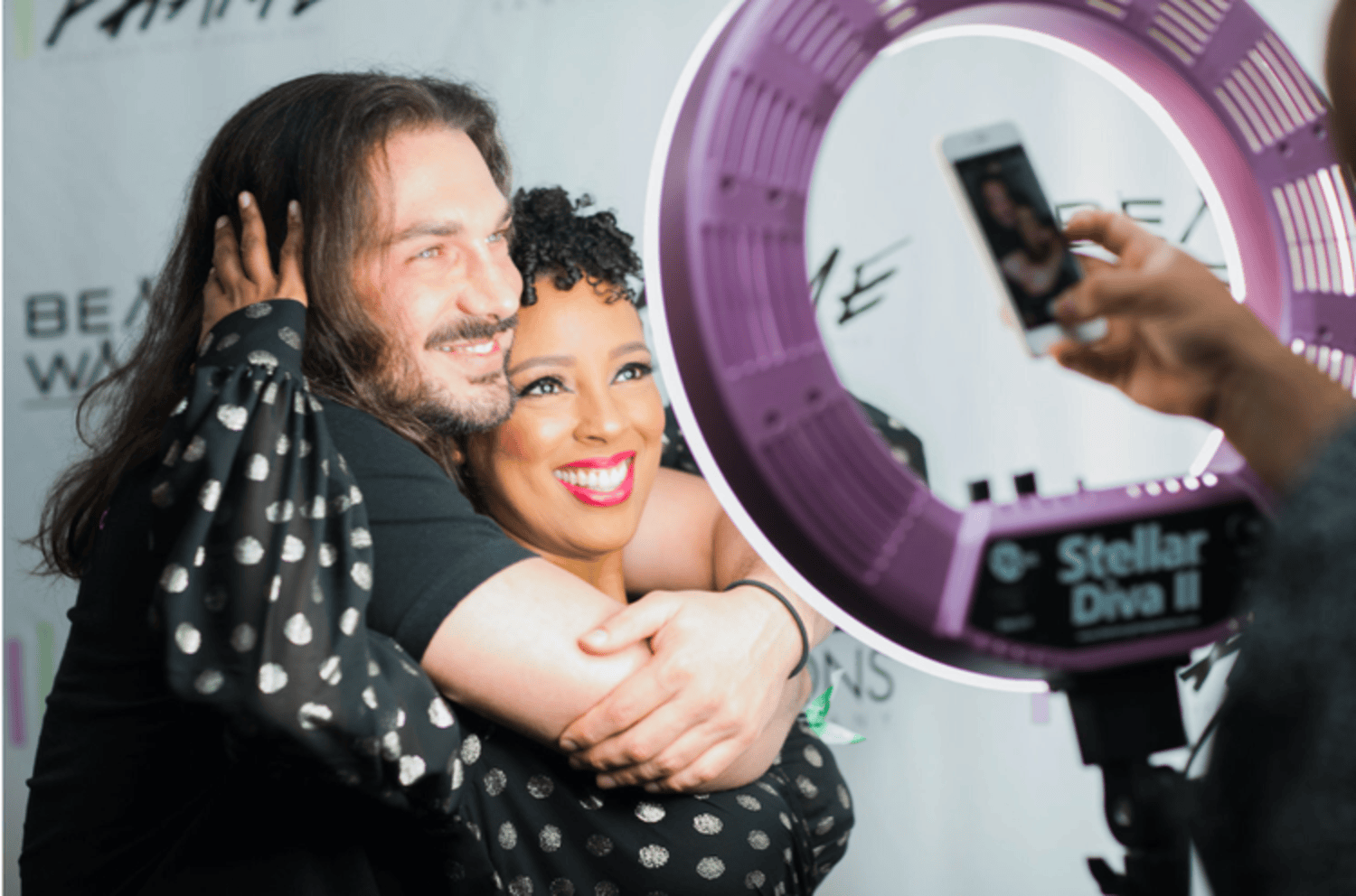 Couple hugging and smiling at an event ring light