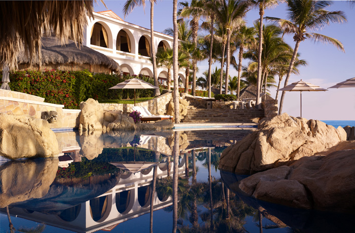Luxury resort villa with infinity pool and palm trees, a destination wedding venue