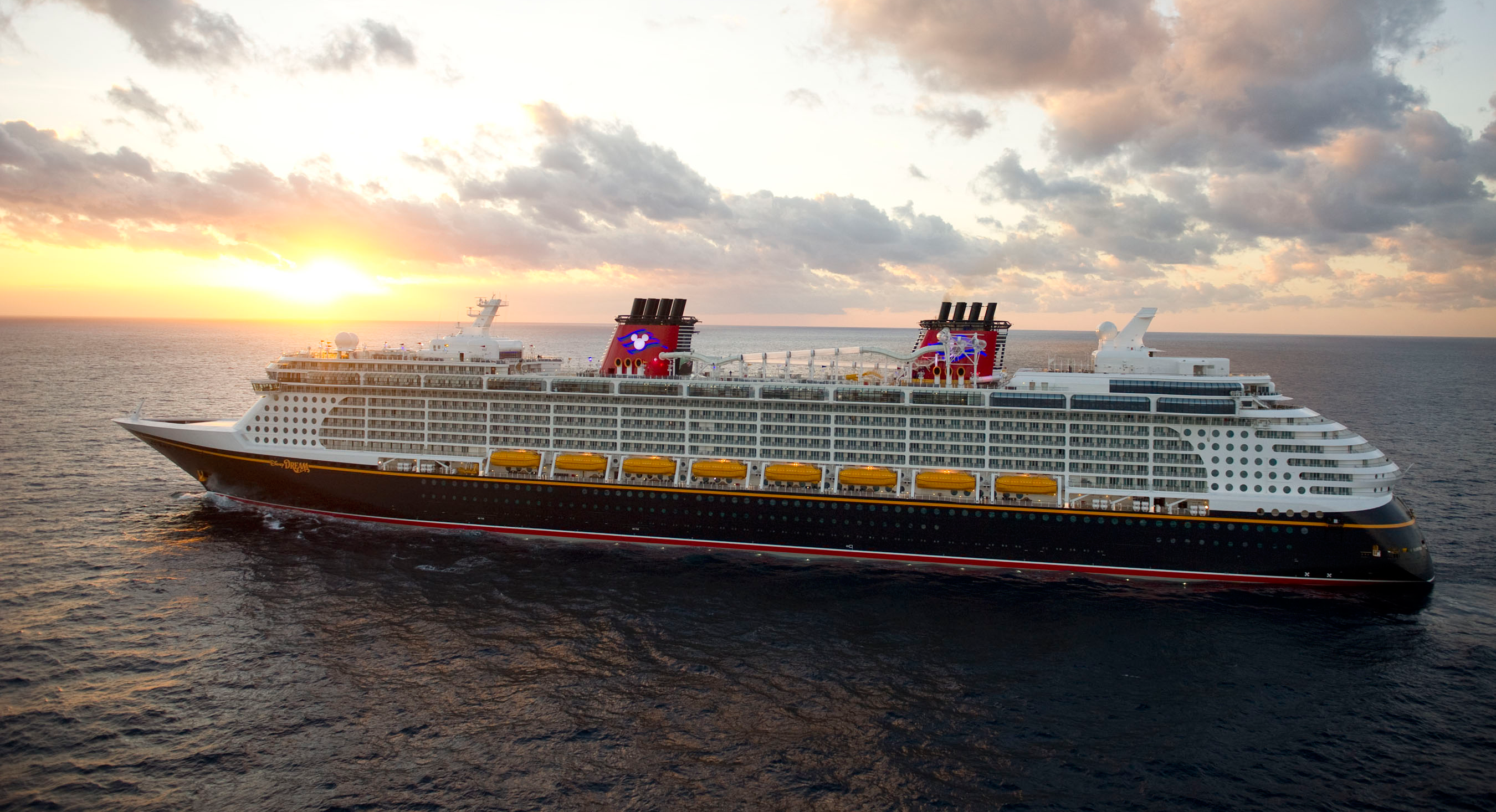 Disney Dream cruise ship at sea during sunset, aerial side view