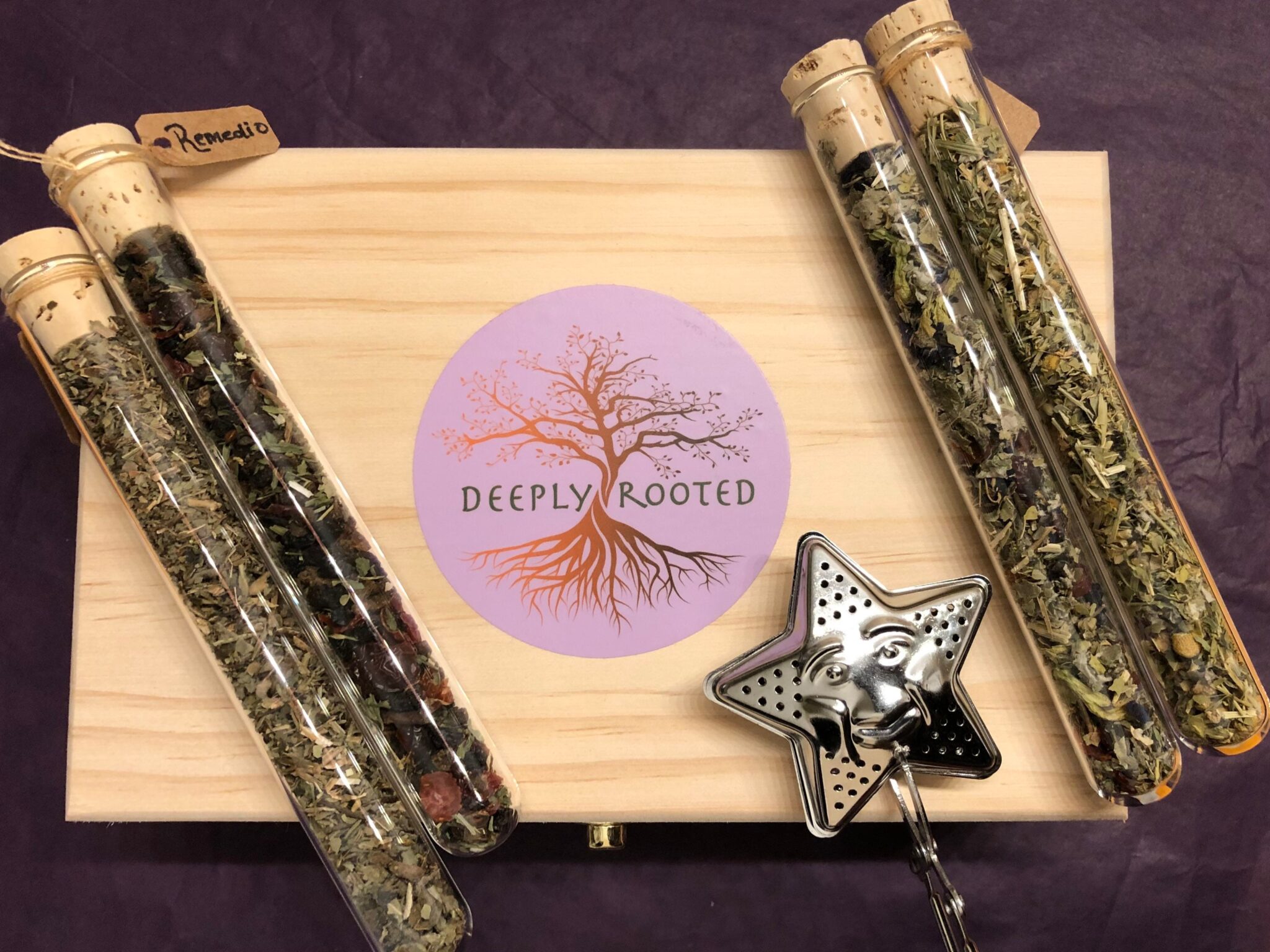 Deeply Rooted wooden gift box with herbal tea vials and a star tea infuser