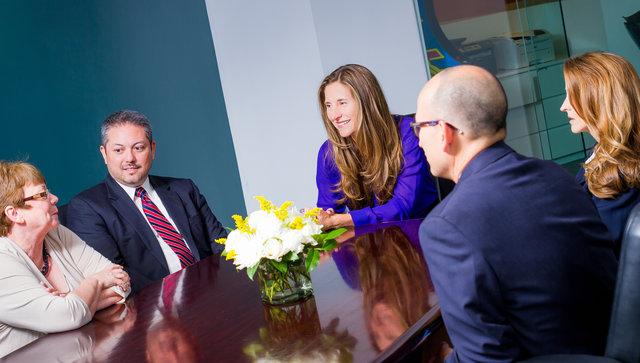 Diane Bolden leading a meeting around a conference table