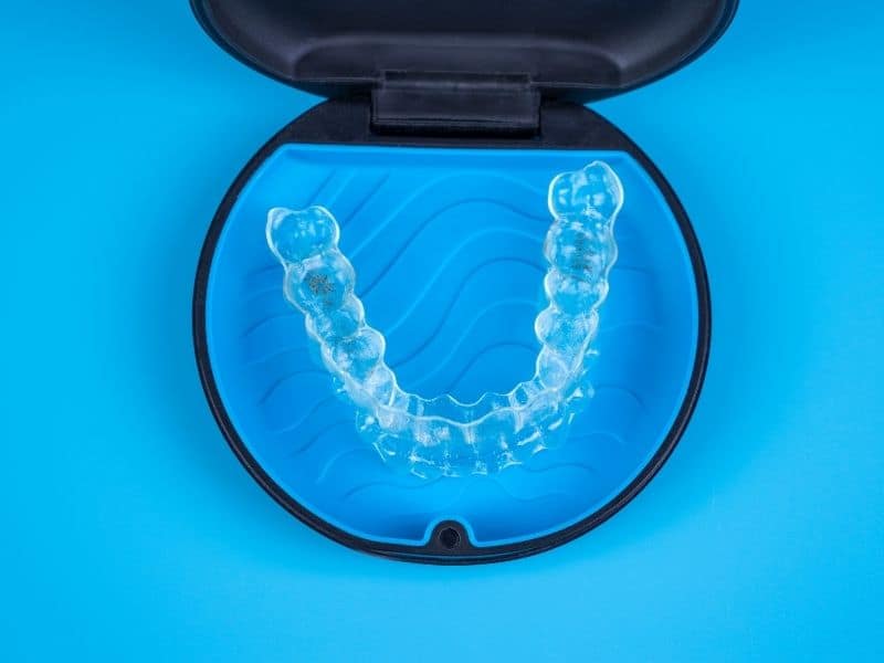 Invisalign clear aligner tray in a blue case