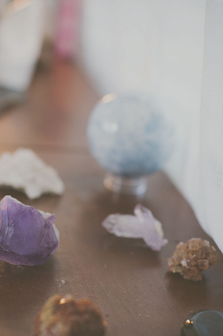 Healing crystals — amethyst, quartz and a crystal sphere on a wooden surface