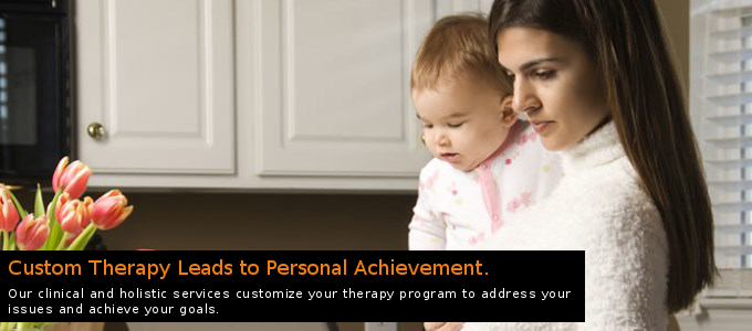 Woman holding a baby in a kitchen with tulips, captioned “Custom Therapy Leads to Personal Achievement”