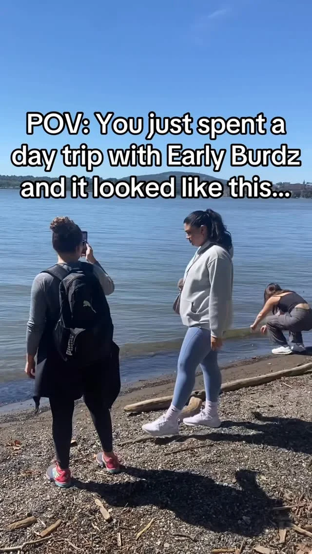 Day trip attendees on a lakeside shore, overlay text: POV you just spent a day trip with Early Burdz