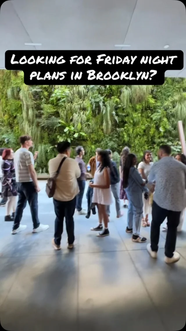 Group gathered in a Brooklyn museum atrium with a living green wall, overlay text: Looking for Friday night plans in Brooklyn?