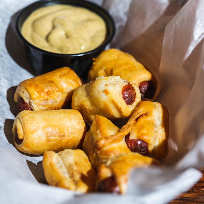 Shareable plate of bites with dipping sauce at Juke Bar NYC
