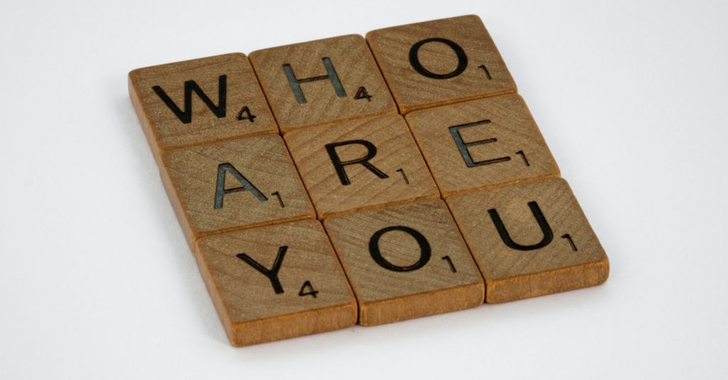 Scrabble tiles arranged to spell WHO ARE YOU