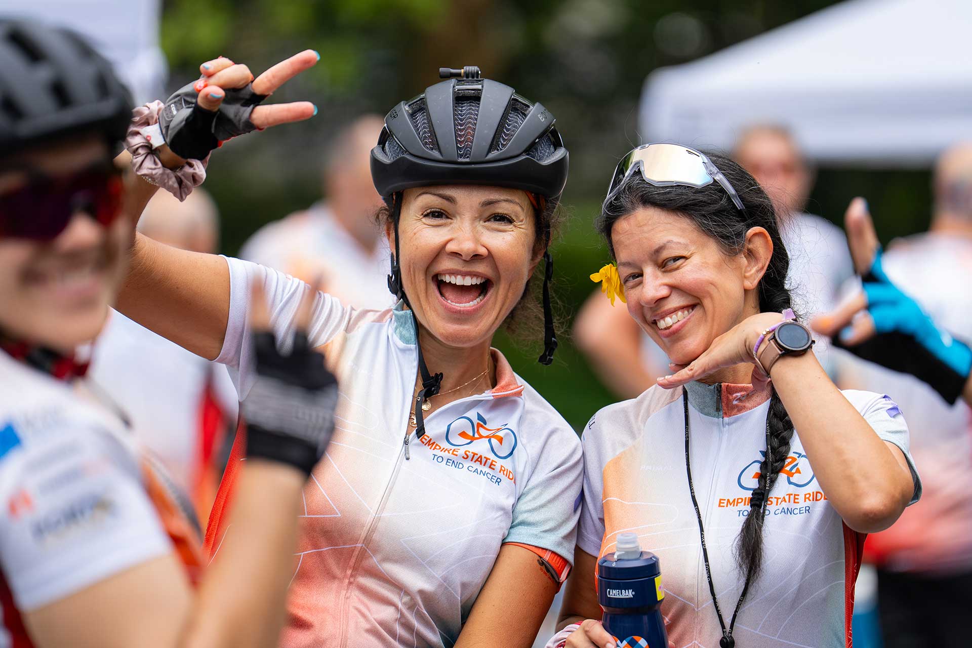Two smiling women in Empire State Ride jerseys at the event