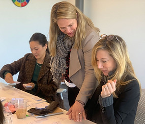 Michelle guiding two women at a workshop table