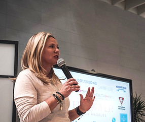 Michelle speaking with a microphone at an event