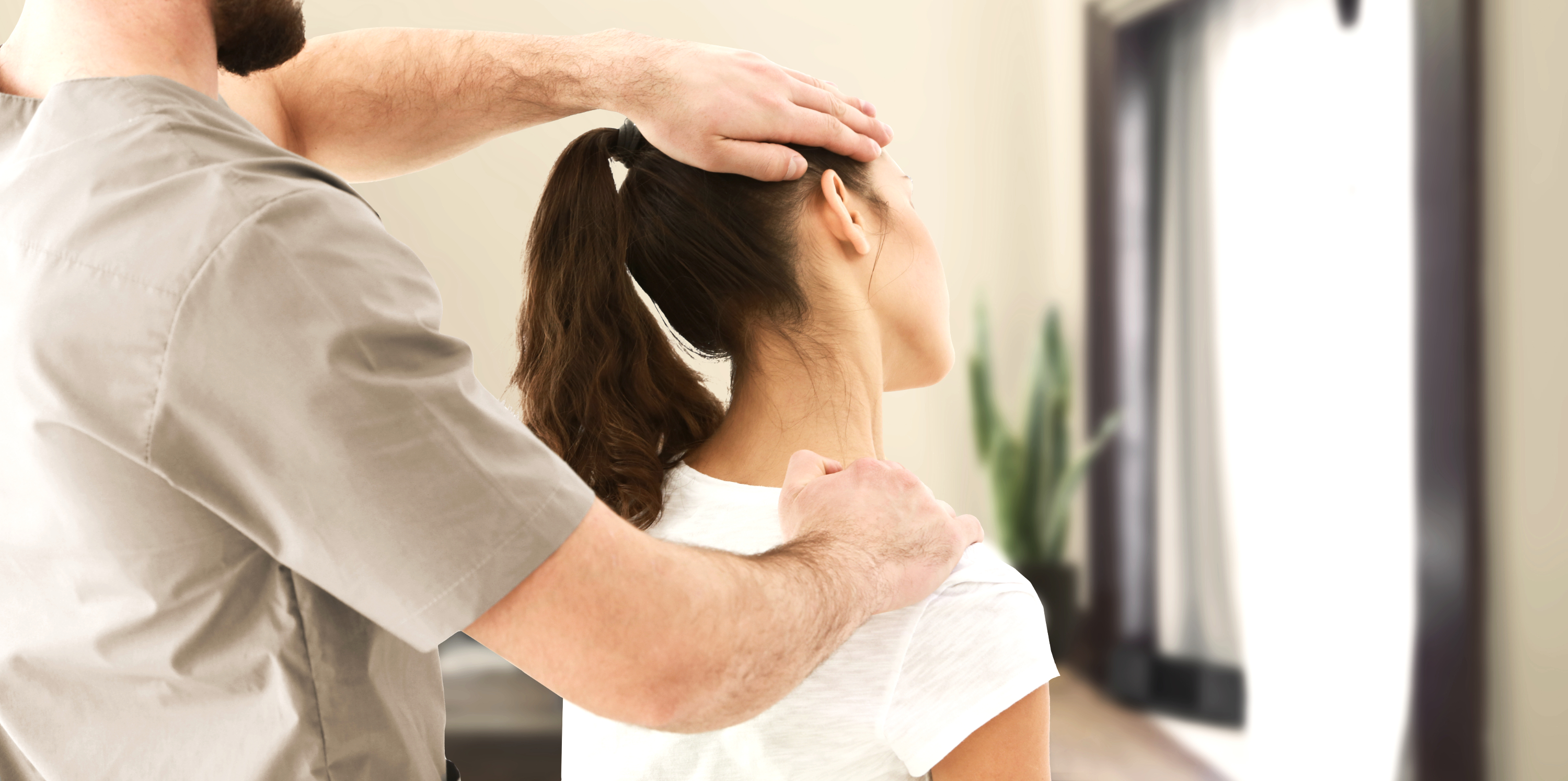 Chiropractor performing a cervical spine adjustment on a patient